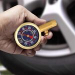 Shrader Tire Gauge, 0-60 PSI with car tire (Campbell Hausfeld DA552400)